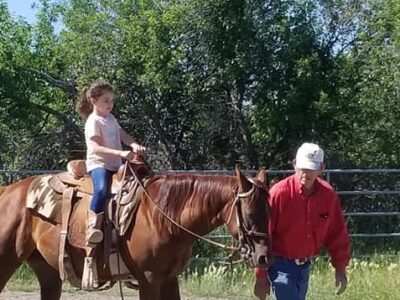 Ward Fenton with a young girl enjoying a ride on a horse
